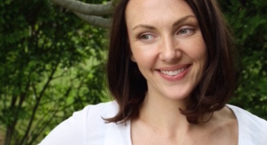 Portrait of woman wearing white sweater smiling